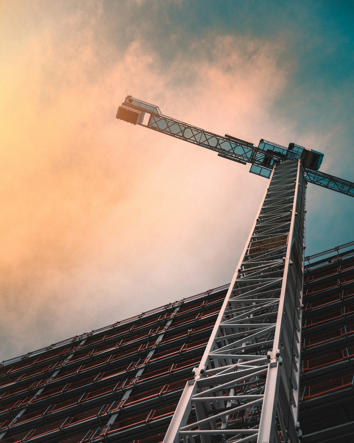 A tower crane rising over an Avon Construction commercial site